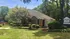 Charming residential building surrounded by lush greenery and a welcoming pathway at The Villages.