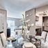 Chic and modern apartment interior featuring an elegantly set glass dining table, stylish open-concept living area, and sleek kitchen design.