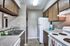 Charming kitchen with sleek countertops, wooden cabinetry, and modern appliances, offering a cozy and practical cooking space.