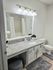 Elegant bathroom with sleek granite countertop, stylish lighting, and cozy decor accents.