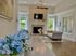 Bright and inviting living room with elegant fireplace, modern decor, and large windows offering ample natural light.