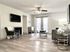 Bright and modern living room with elegant hardwood flooring, contemporary furniture, and stylish decor.