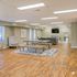 Spacious and elegantly designed open-plan living area with modern decor, featuring sleek wooden floors, plush seating, and ample natural light.