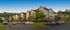 Charming apartment complex nestled in lush greenery, featuring modern architecture and ample parking.