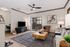 Inviting living room with modern decor, featuring a cozy seating area, elegant wooden coffee table, and chic floor-to-ceiling patio doors leading to a serene outdoor space.