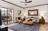 Charming living room with modern decor, featuring a cozy sofa, elegant wooden coffee table, and a large window opening to a sunny patio.