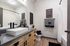 Modern bathroom featuring a sleek rectangular sink, stylish wood cabinetry, and elegant black accents creating a contemporary feel.