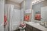 Chic bathroom featuring modern fixtures, cozy decor, and inviting warm-toned towels for a relaxing atmosphere.