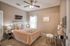Cozy bedroom with elegant decor, featuring a plush bed, warm lighting, and stylish wall art.