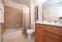 Modern bathroom with elegant tile design, sleek vanity, and bright lighting, perfect for a stylish home.