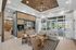 Chic, modern lounge area with stylish lighting, cozy seating, and expansive windows offering a poolside view.
