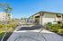 Luxurious outdoor space featuring a modern hammock area, lounge chairs, and a sparkling pool with contemporary architecture.