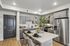 Modern kitchen design featuring sleek grey cabinets, stainless steel appliances, and a chic island with elegant seating.