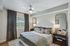 Elegant bedroom with plush bedding, stylish mirrors, and soothing natural light, offering a calming retreat.