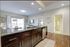 Elegant open-concept living area featuring modern kitchen with granite countertops, cozy dining space, and inviting natural light.