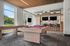 Luxurious lounge featuring a stylish billiard table, sleek bar seating, and large windows with scenic views, ideal for social gatherings.