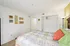 Cozy bedroom with floral bedding, vibrant pillows, and calming wall decor creating a serene ambiance.
