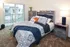 Charming bedroom with vibrant patterned bedding, cozy ambiance, and balcony access.