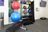 Modern fitness room featuring vibrant exercise balls, kettlebells, and a versatile workout bench, perfect for an energizing home workout experience.