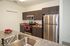 Modern kitchen with sleek stainless steel appliances, dark wood cabinetry, and elegant granite countertops.