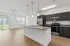 Modern open-concept kitchen and living area with sleek finishes, stainless steel appliances, and abundant natural light.