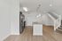 Modern open-concept kitchen with granite countertops, sleek stainless steel appliances, and stylish pendant lighting.