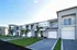 Contemporary townhomes with sleek design, lush landscaping, and private garage spaces in a tranquil neighborhood.