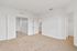 Bright and spacious bedroom with plush carpet, ample closet space, and pristine white walls, offering a blank canvas for personalization.