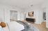Inviting bedroom with plush carpeting, stylish decor, and a spacious walk-in closet, perfect for modern living.