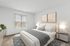 Bright, cozy bedroom with plush carpeting, featuring a large bed adorned with elegant bedding, modern nightstands, and soft ambient lighting.