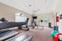 Bright and inviting fitness center with modern exercise equipment, large windows, and vibrant decor.