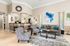 Elegant open-concept living room with stylish furniture, plush seating, decorative wall art, and a cozy ambiance perfect for relaxation.