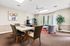 Inviting living room with contemporary decor, featuring a modern dining table, cozy seating area, and vibrant artwork.