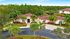 Luxurious single-story villa surrounded by lush green palm trees and scenic views, ideal for serene living.
