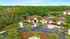 Charming residential property surrounded by lush greenery, featuring a welcoming entrance, elegant palm trees, and a serene pool area.