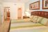 Bright and inviting bedroom with a comfortable bed and elegant decor, adjacent to a walk-in closet and a modern bathroom, perfect for relaxation and convenience.