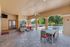 Elegant patio area with comfortable seating, ceiling fans, and pool view, perfect for relaxation and entertaining.