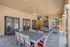 Luxurious outdoor patio with elegant seating area, modern dining table, and ceiling fans providing a perfect space for relaxation and entertainment.