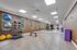 Bright and spacious fitness room with exercise equipment, mirrors, and wooden flooring for a dynamic workout experience.