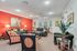 Chic and welcoming living room with vibrant red accent wall, elegant sofas, and stylish decor for a cozy atmosphere.