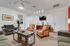 Inviting living room with elegant decor, featuring a cozy arrangement of armchairs, stylish sofa, and modern art accents.