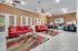 Elegant modern room featuring stylish red sofas, chic glass coffee tables, and a trendy decor with vibrant colors, ideal for relaxation or social gatherings.