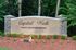 Elegant entrance sign for Capital Walk, highlighting luxury apartment homes surrounded by lush greenery.