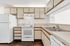 Inviting apartment kitchen featuring modern appliances, ample cabinetry, and sleek countertops for an ideal cooking space.