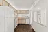 Bright kitchen with modern appliances, wood flooring, and ample cabinetry, offering a clean and inviting space for culinary creativity.