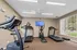Bright and inviting fitness center with modern exercise equipment including treadmills and elliptical, perfect for a healthy lifestyle.