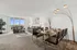 Bright and inviting living-dining area with modern furniture, elegant dining setup, large windows offering stunning views, and stylish decor.