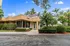 Charming residential building facade with lush tropical landscaping and a bright, inviting exterior.