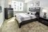 Bright and cozy bedroom with modern dark wood furniture and stylish decor, perfect for relaxation.