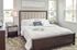 Elegant bedroom with a plush king-sized bed, chic nightstands, and modern decor, bathed in natural light from large windows.